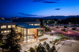 Drone photo of the Lory Student Center North side entrance at dusk with the campus in the background.